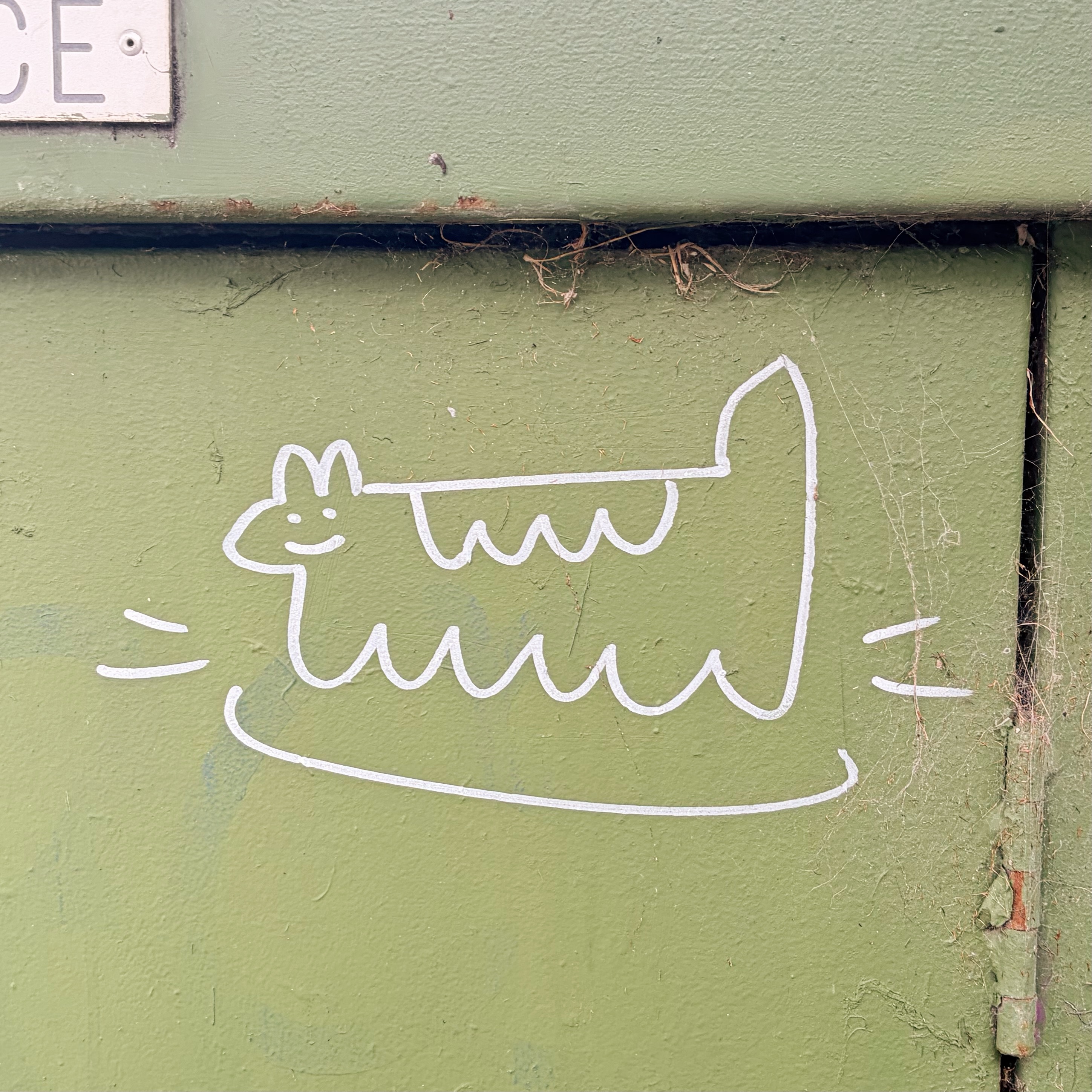 Graffiti on the back of a dumpster.